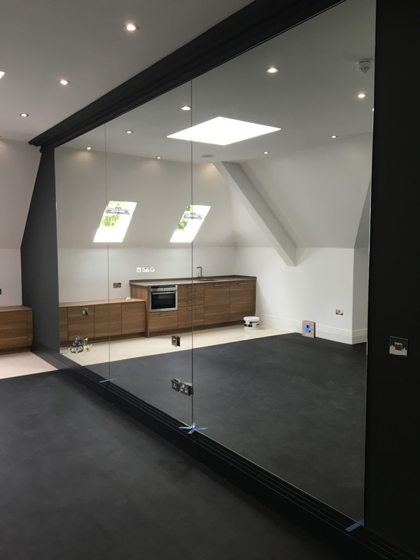 Frameless glass partition in loft conversion by Clapham Junction glaziers