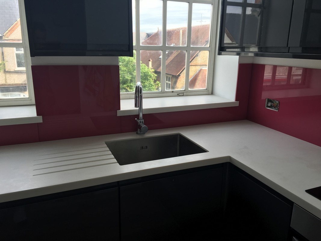 Deep plum coloured glass splashback in modern Clapham Junction kitchen