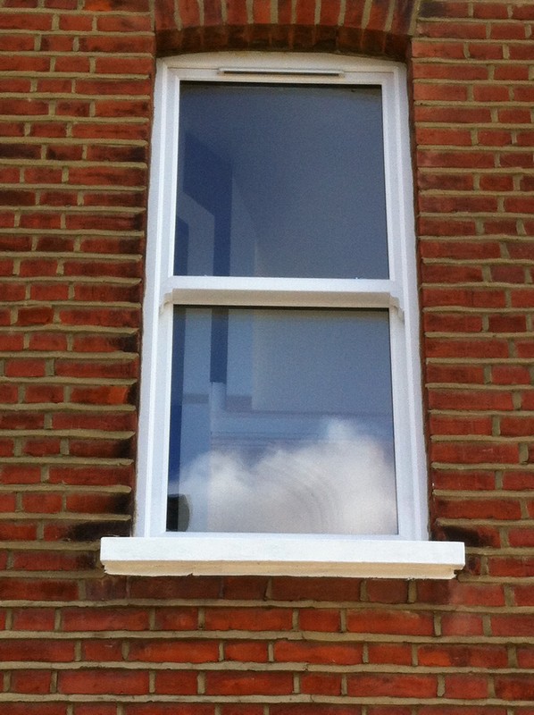 uPVC sash window on Victorian red brick house in Clapham Junction